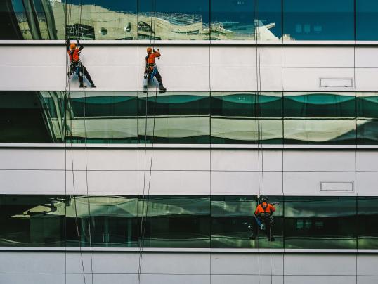 Image of 3 persons cleaning windows