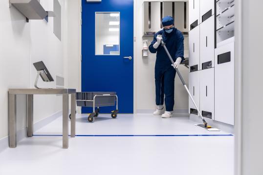 Image of a person cleaning a white room